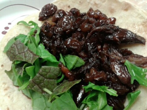 Pork cheek taco: golden raisins and dried cherries in a red wine reduction. Mustard greens and arugula.